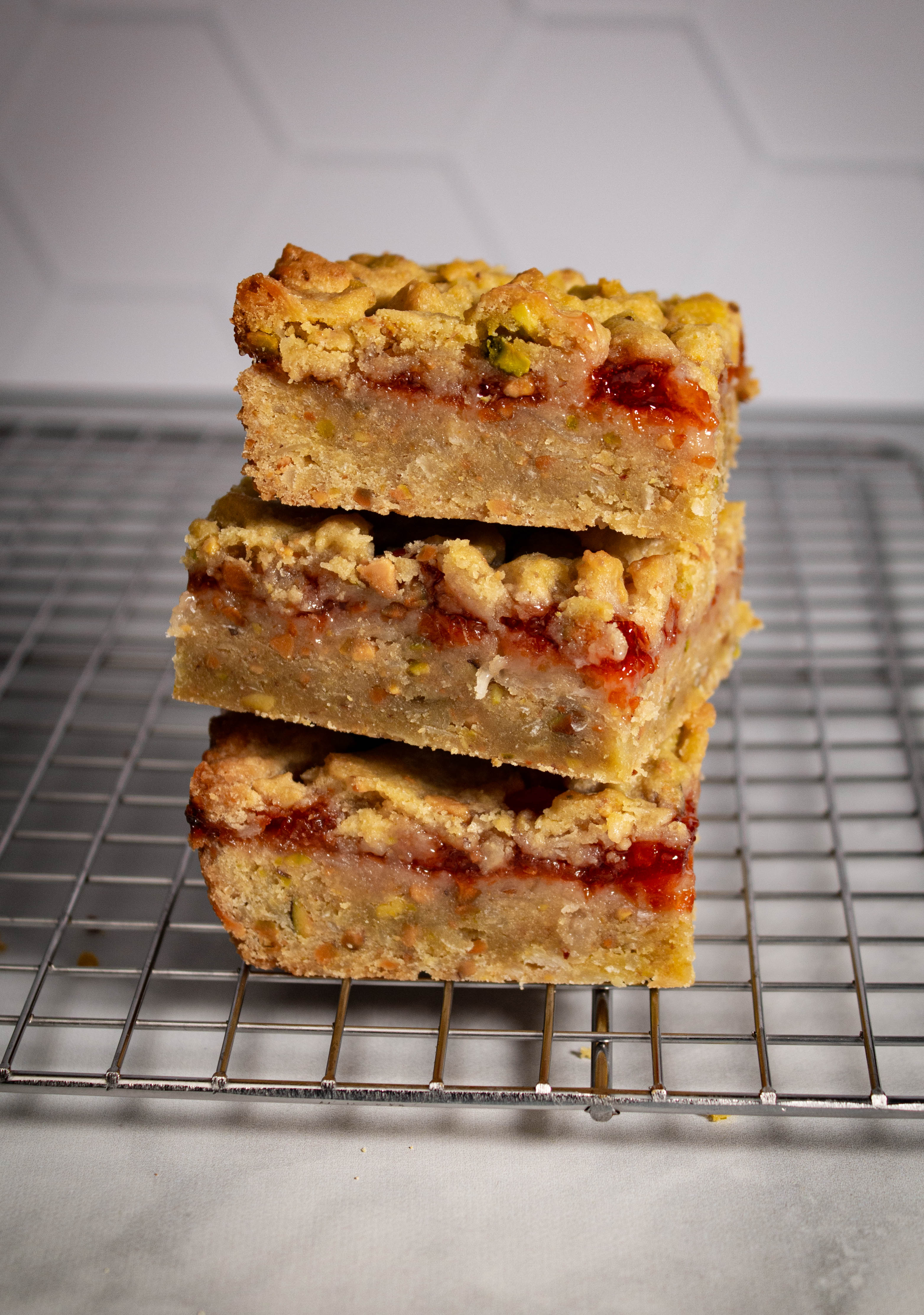 Stack of 3 bars on a cooling rack in a kitchen setting.